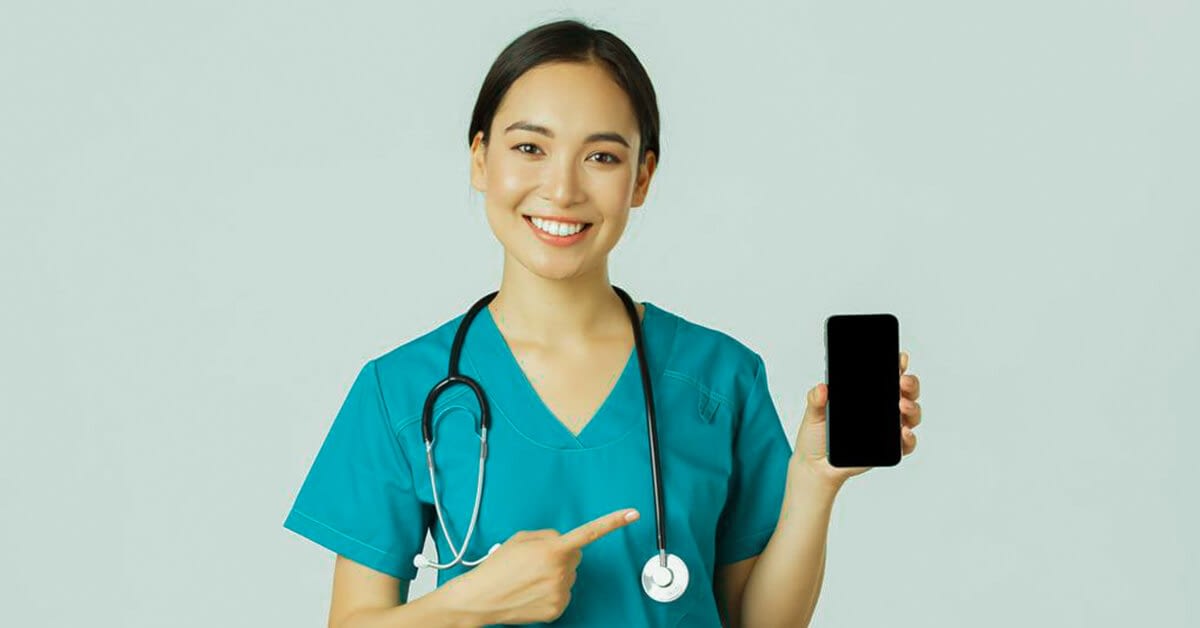 female doctor in scrubs showing mobile phone for telehealth services