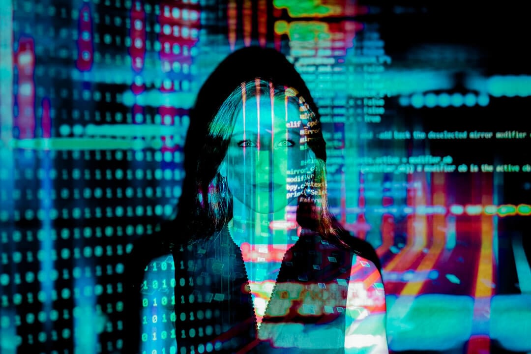 woman standing, projected with a stream of computer codes