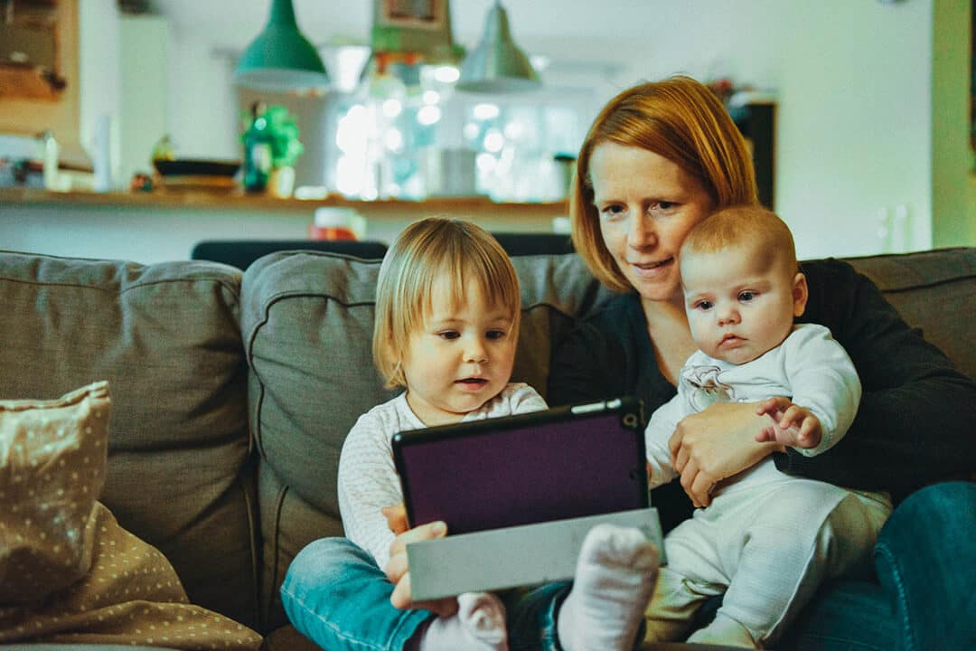 mother with kids browsing on a tablet
