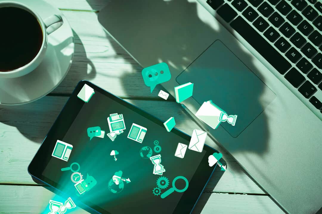 app icons floating out from a tablet screen on a desk