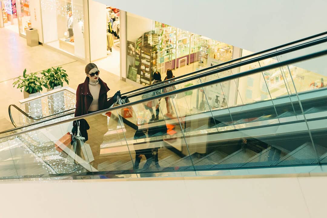 woman on escalator shopping mall