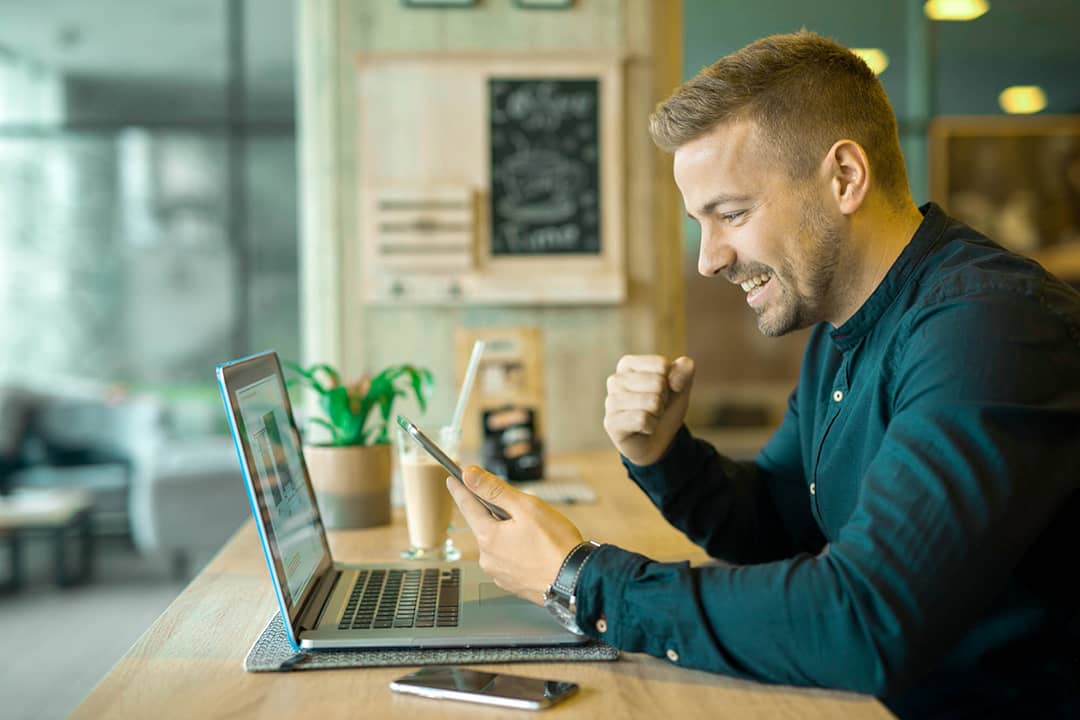 happy client with laptop in coffee shop