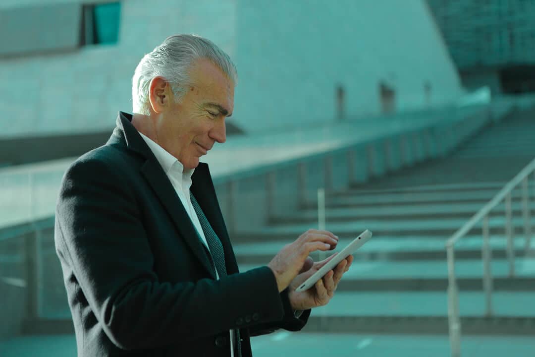 businessman outdoors looking at his smart phone